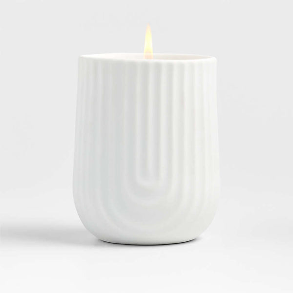 Load image into Gallery viewer, White porcelain candle with a textured design on the body, featuring a lit flame on top.